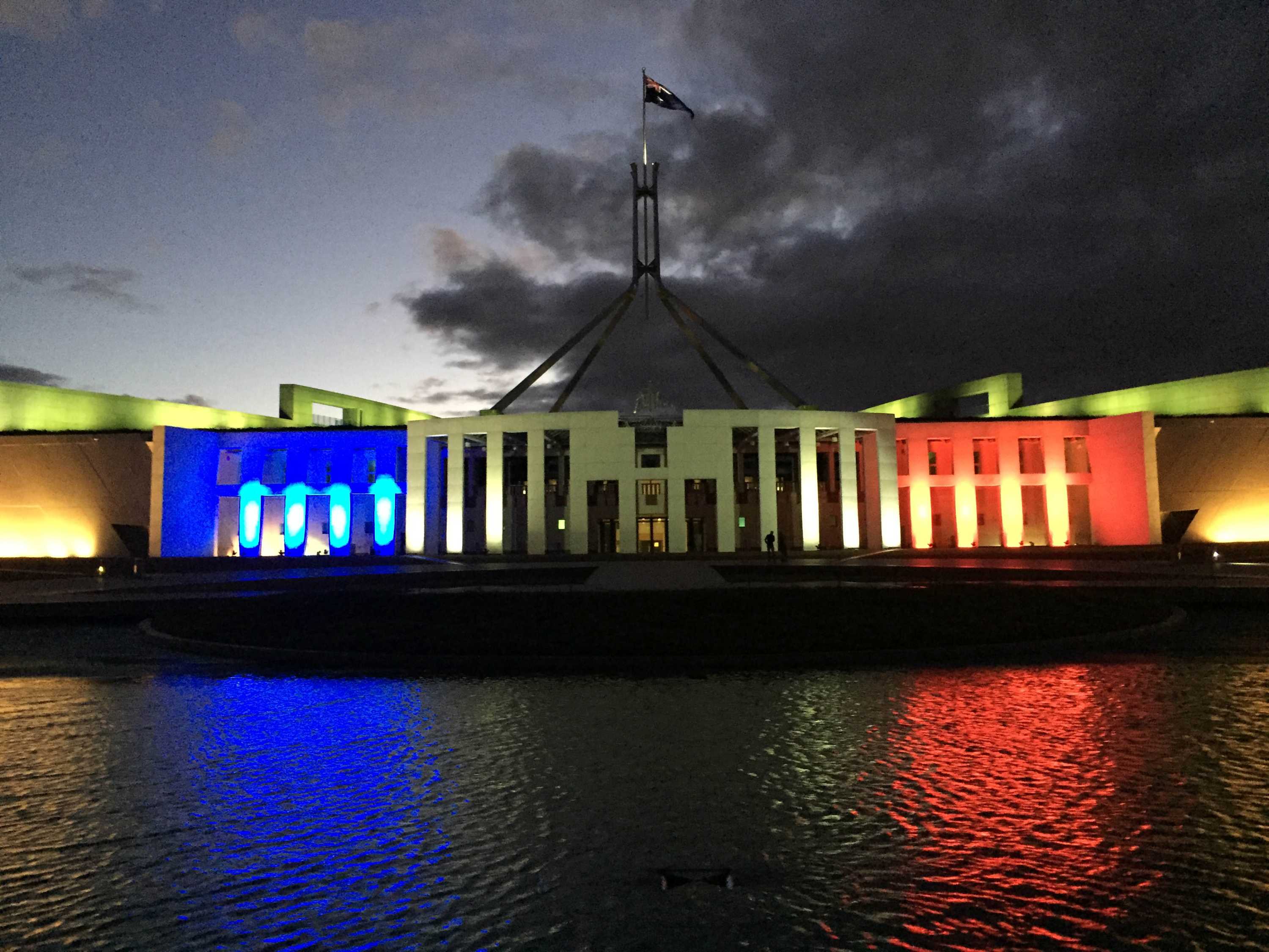 Parliament House in Canberra is lit in the blue, white and red of the French Tricolore.